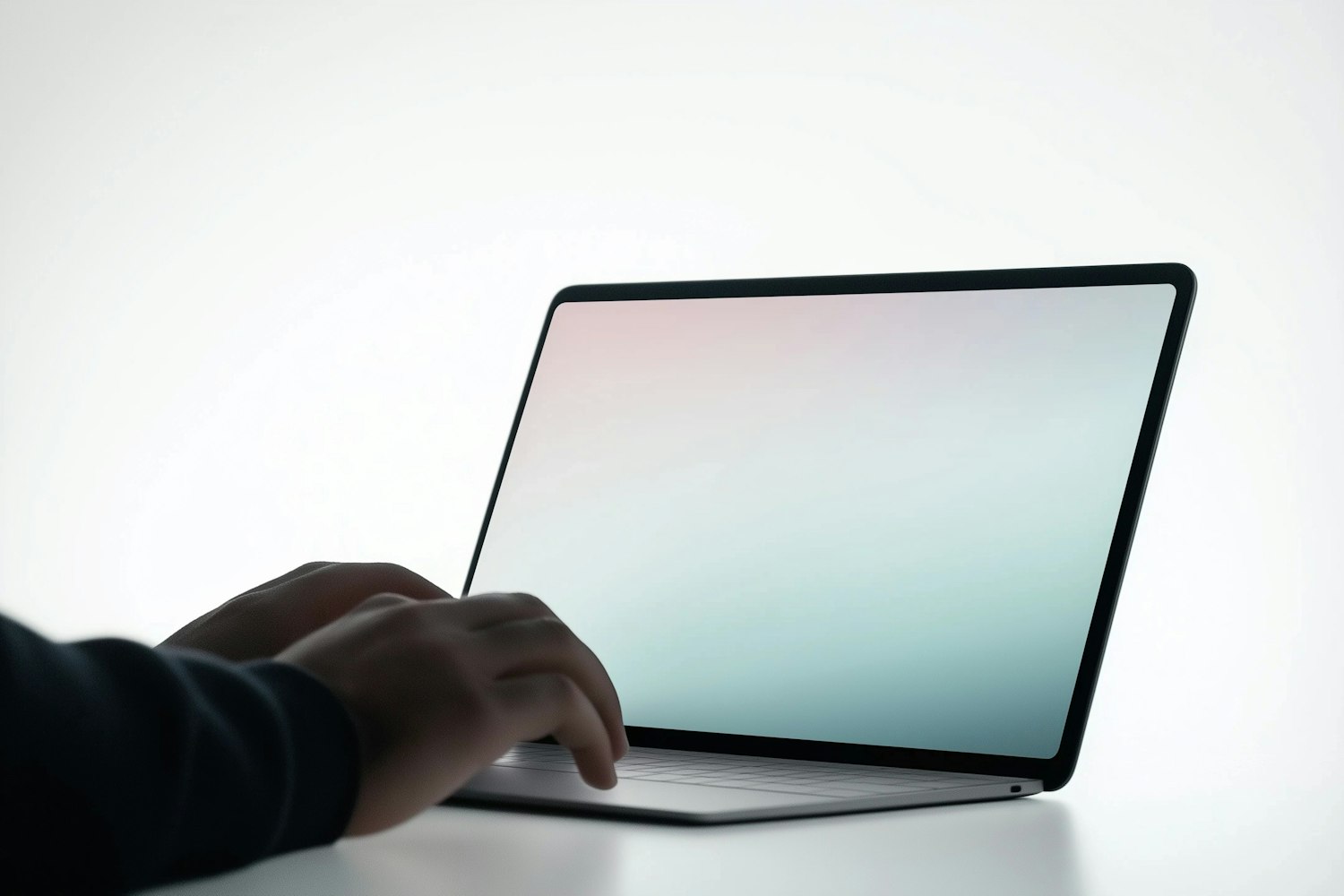Hands typing on a laptop with a pastel screen